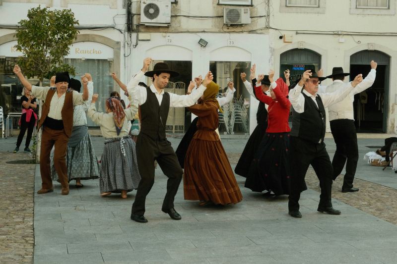 a-group-of-people-dancing-in-front-of-a-building-portugal