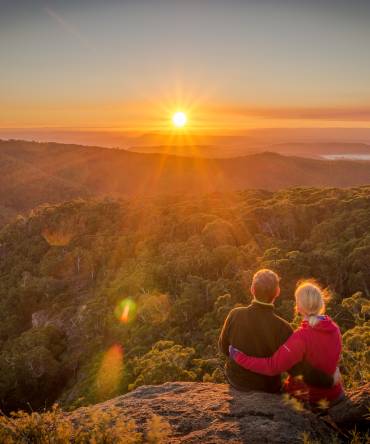 A-young-couple-enjoying-the-beautiful-sunrise-on-Mount-Kaputar-in-New-South-Wales-Australia