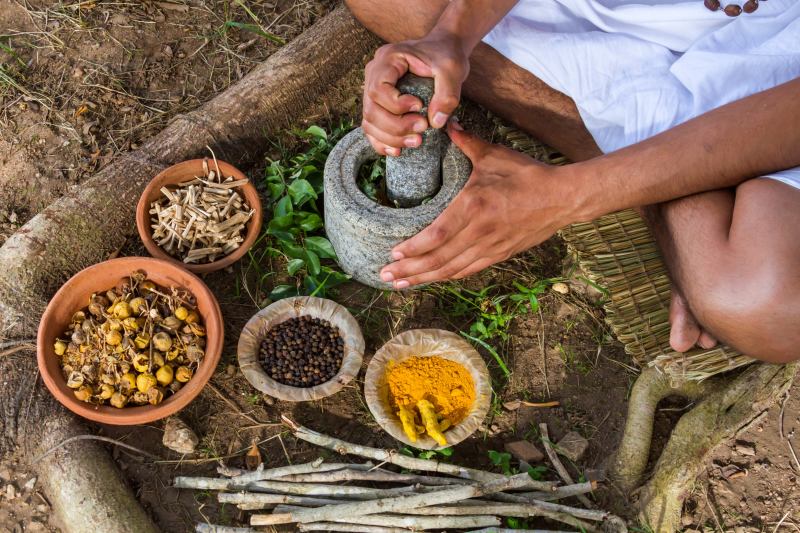 A-young-man-preparing-ayurvedic-medicine-in-the-traditional-manner