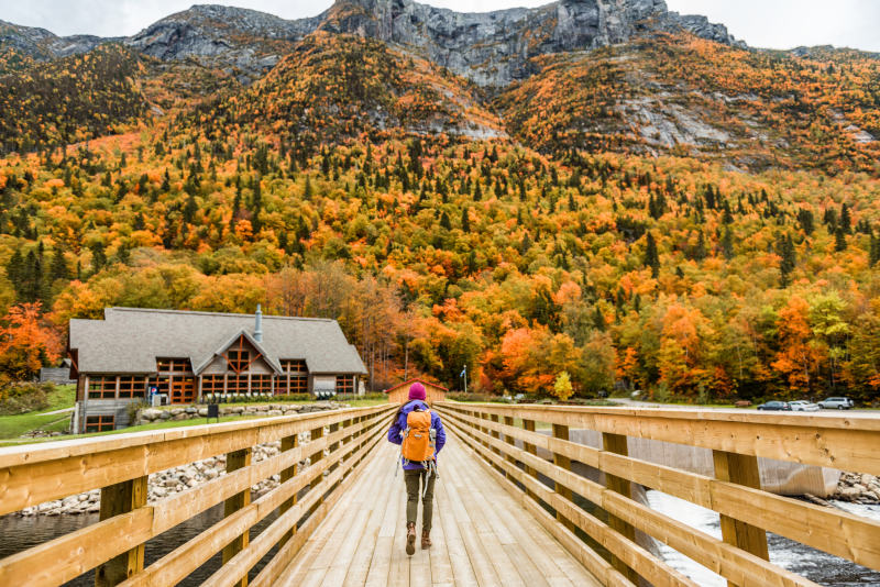 Autumn-nature-hiker-girl-walking-in-national-park-in-Quebec-with-backpack