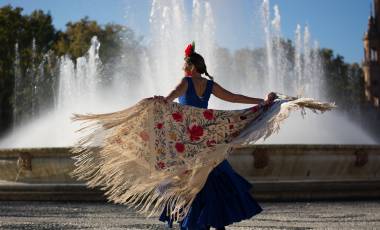 Beautiful woman dancing flamenco near the fountain