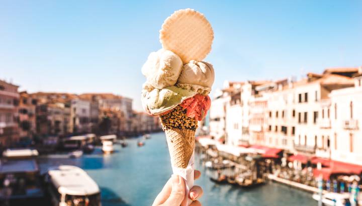 Delicious icecream in beautiful Venezia, Italy in front of a canal and historic buildings