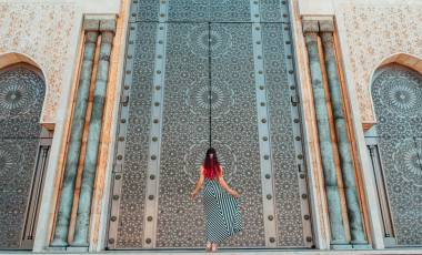 Morocco travel guide - Girls standing in front of greatest mosque Hasan II in Morocco, Africa - Top six destinations we can't wait to visit again