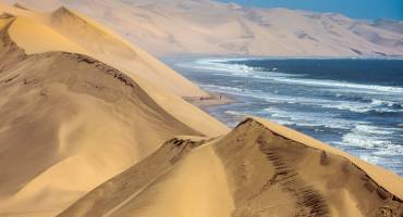 Atlantic coast of Walvis Bay, Namibia. Ocean surf with foamy waves - Namibia travel guide