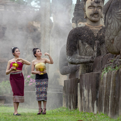 Beautiful Lao woman splashing water during Songkran Festival, Lao Vientiane Tradition, Asia - Laos travel guide