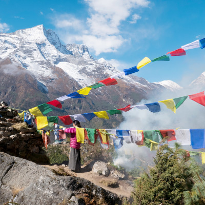 Nepali women replacing prayer flags, Namche Bazaar village, Sagarmatha Park, Himalayas, Nepal
