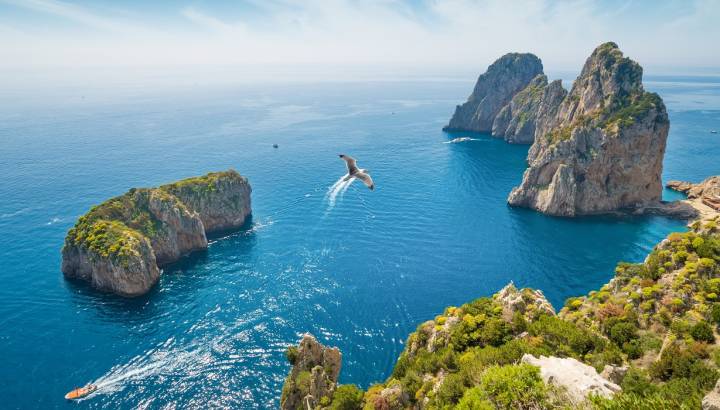 Enchanting Travels Italy Tours Aerial view of famous Faraglioni rocks from Capri island, Italy.