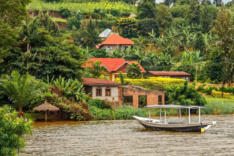 Roof-boat-anchored-at-the-coast-with-rwandan-village-in-the-background-Kivu-lake-Rwanda