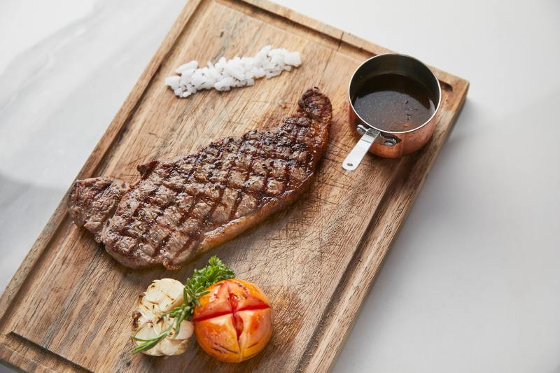 striploin-steak-served-roasted-vegetables-gravy