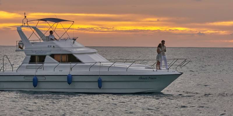 Couples enjoying in cruise during sunset